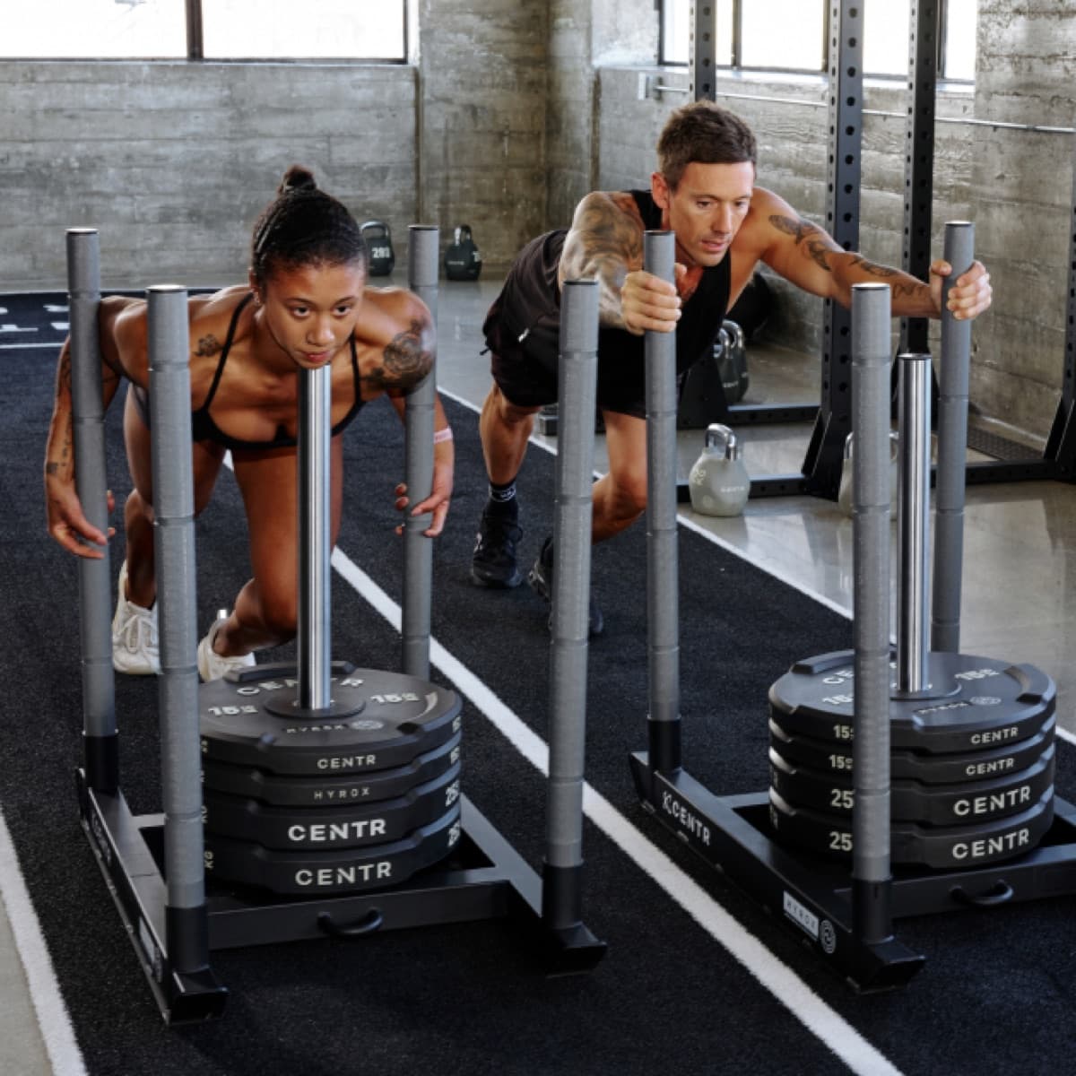 Athletes training on Centr x HYROX competition sleds