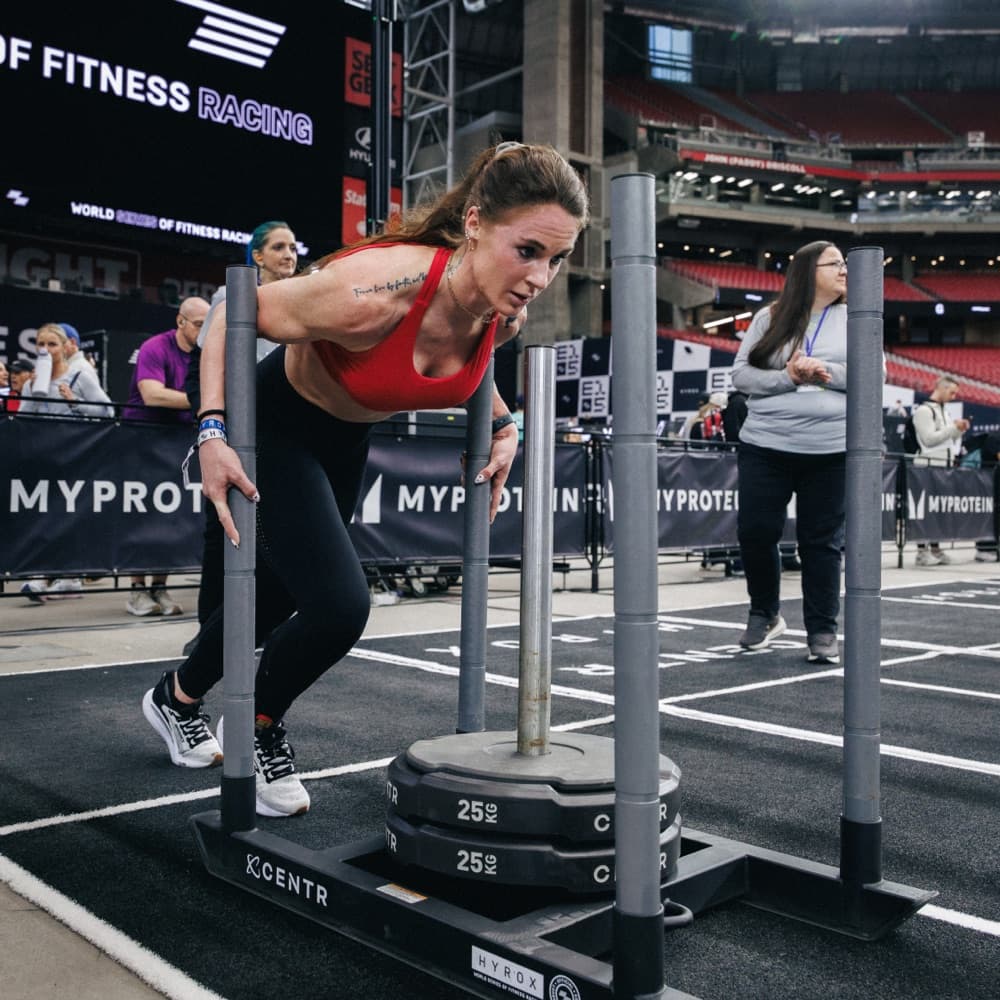 Athlete pushing a weighted sled
