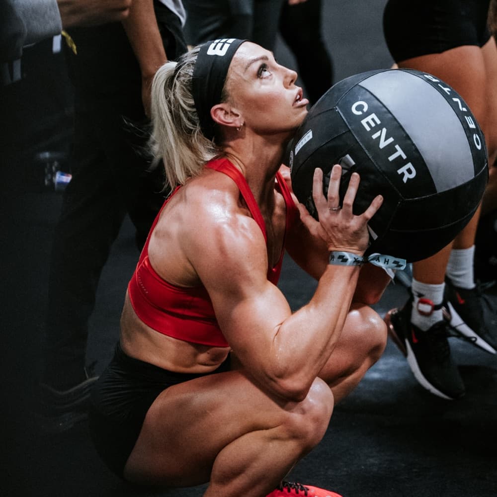 Athlete performing wall balls at a HYROX event